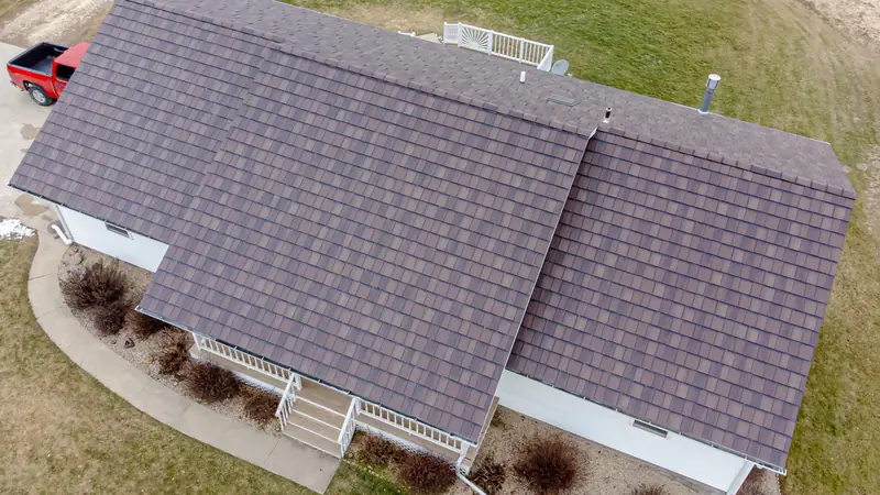 Aerial view of a gray asphalt-style shingle roof on a one-story house