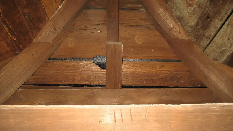 Old wooden roof boards and rafters seen from an attic